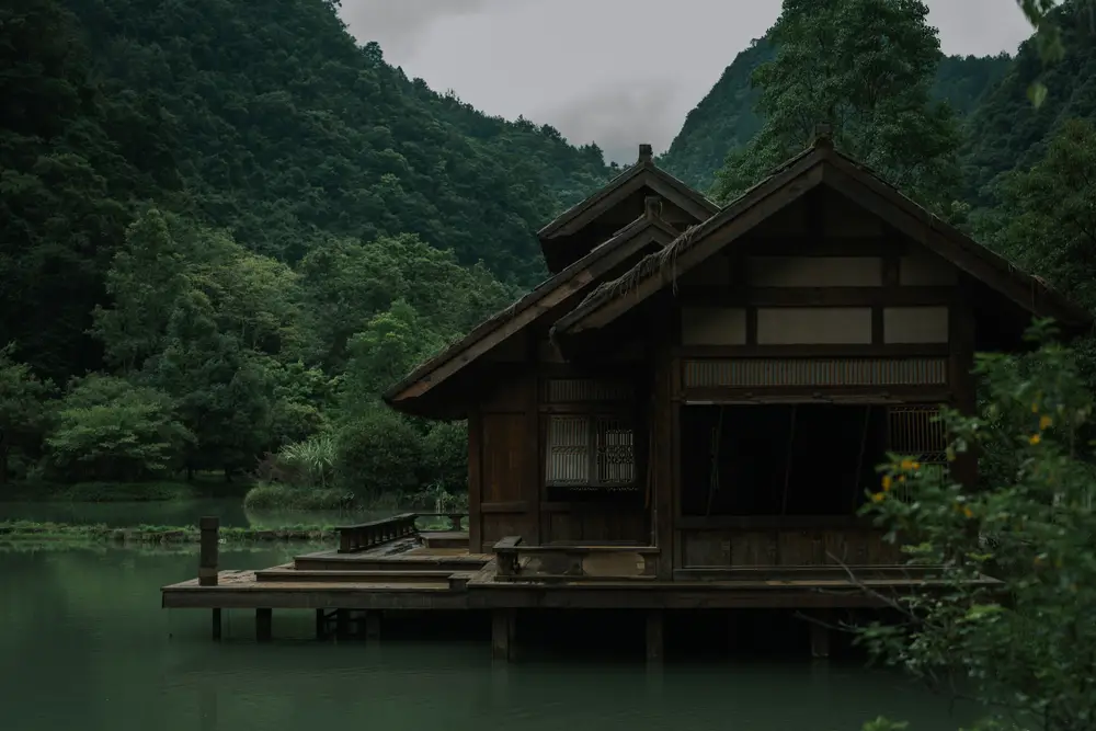 临水木质古宅 掩映在山谷茂密绿林之中