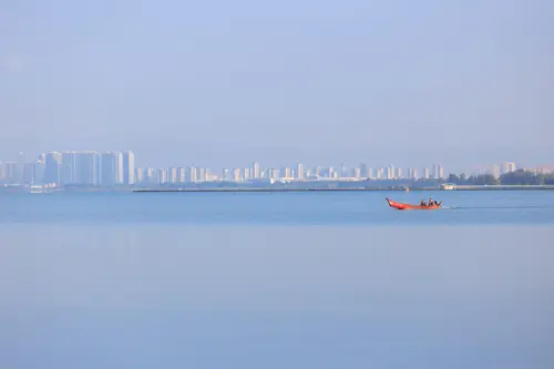 8192x5464 Desktop Wallpaper - 平静湖面红色小船 远景雾色城市天际线